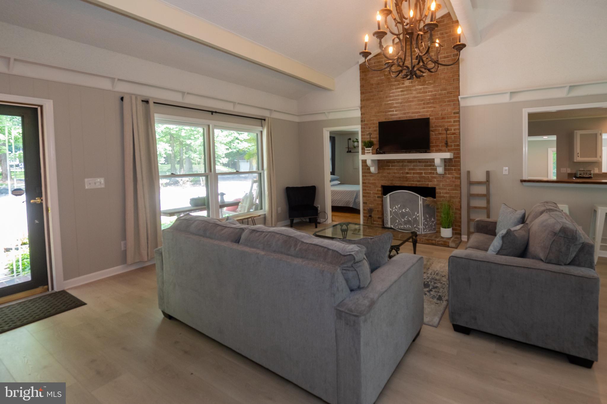 31091 Carioca Road Delmar, MD 21875 - Photo 5 of 28 a living room with furniture a fireplace and a flat screen tv