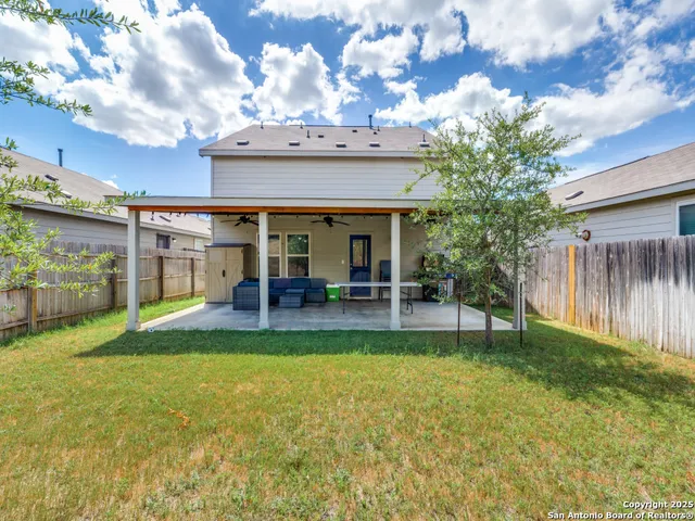 a view of a house with backyard porch and sitting area