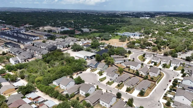 an aerial view of residential houses with outdoor space
