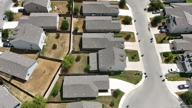 an aerial view of houses with outdoor space