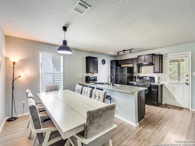 a view of a dining room with furniture and wooden floor