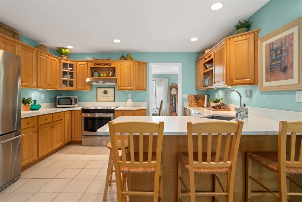 105 Flint Farm Road Middleton, MA 01949 - Photo 11 of 25 a kitchen with stainless steel appliances a stove a sink dishwasher and a refrigerator