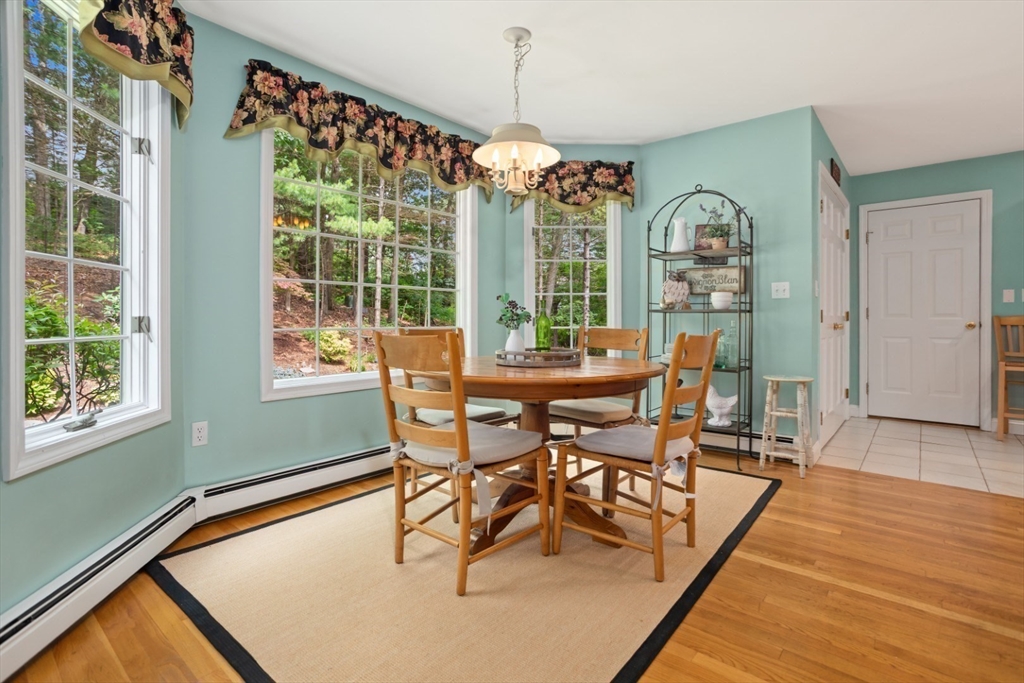 105 Flint Farm Road Middleton, MA 01949 - Photo 12 of 25 a dining room with furniture a chandelier and wooden floor