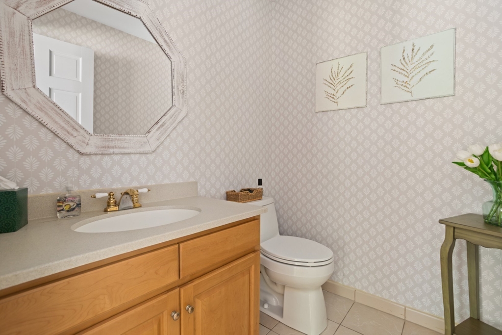 105 Flint Farm Road Middleton, MA 01949 - Photo 13 of 25 a bathroom with a granite countertop toilet sink and mirror