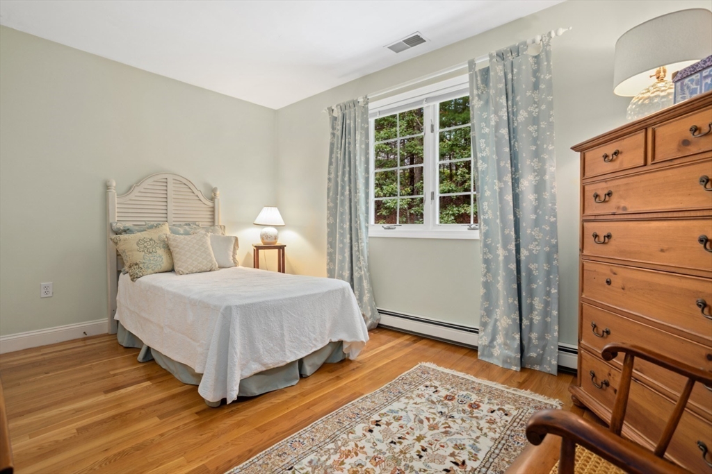 105 Flint Farm Road Middleton, MA 01949 - Photo 19 of 25 a bedroom with a bed and wooden floor