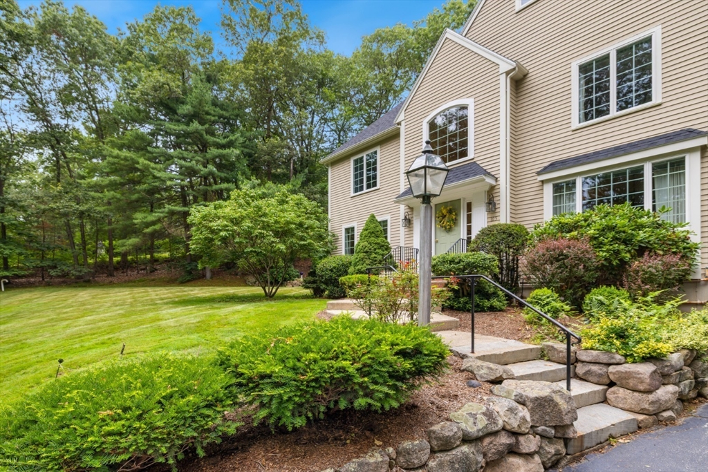 105 Flint Farm Road Middleton, MA 01949 - Photo 2 of 25 a front view of a house with a yard and trees