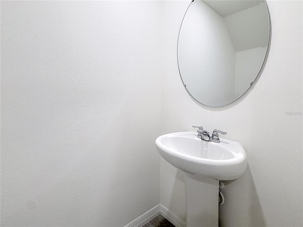 6632 Druid Way St. Cloud, FL 34773 - Photo 17 of 38 a bathroom with a sink a mirror and a gate