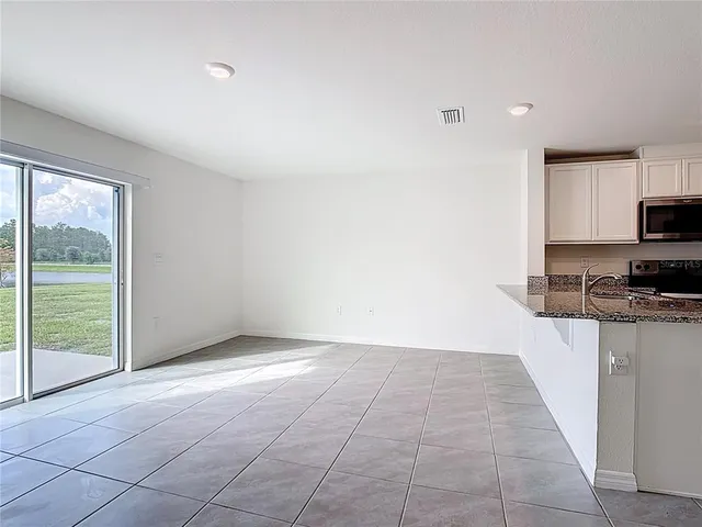 a view of a kitchen with microwave and stove