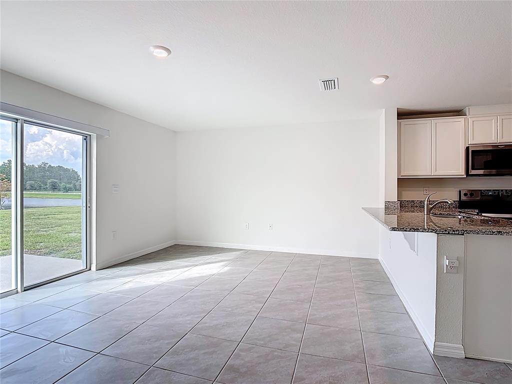 6632 Druid Way St. Cloud, FL 34773 - Photo 22 of 38 a view of a kitchen with microwave and stove