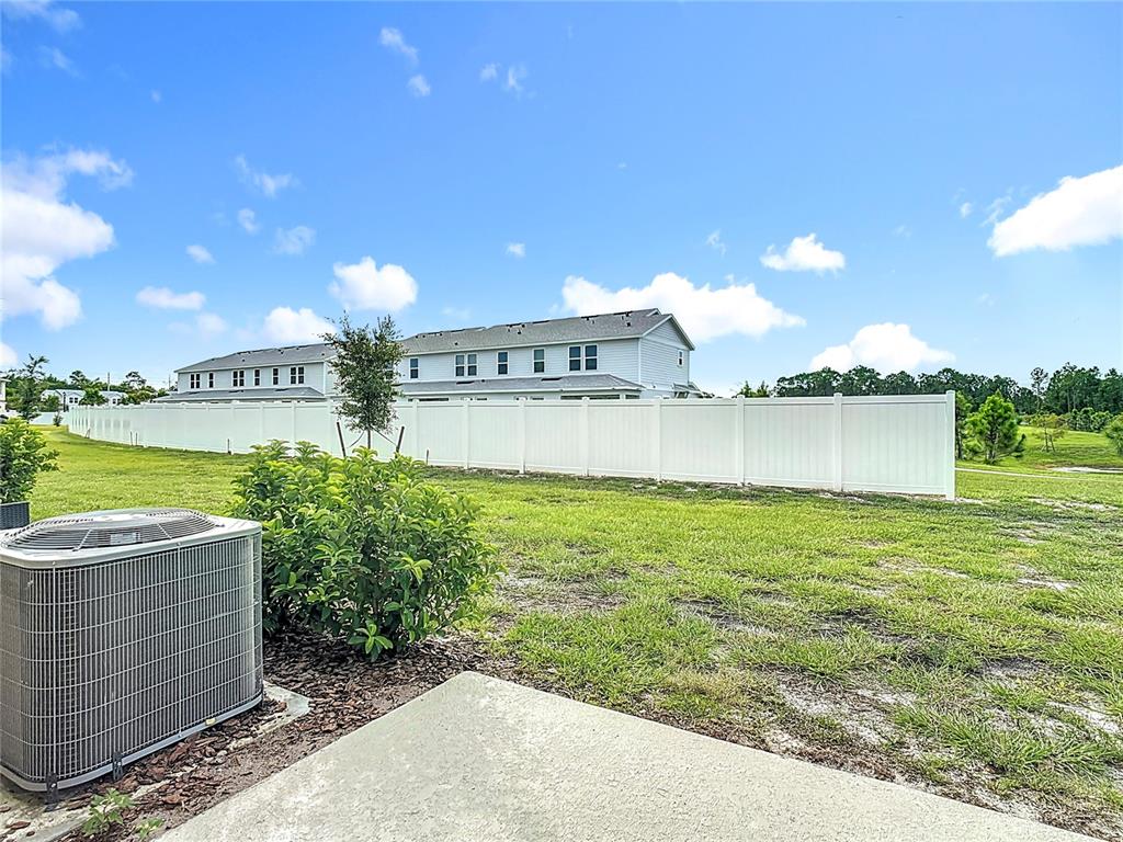 6632 Druid Way St. Cloud, FL 34773 - Photo 29 of 38 a view of a garden with a building in the background