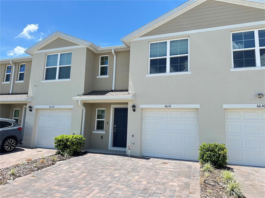 6632 Druid Way St. Cloud, FL 34773 - Photo 3 of 38 a front view of a house with a yard