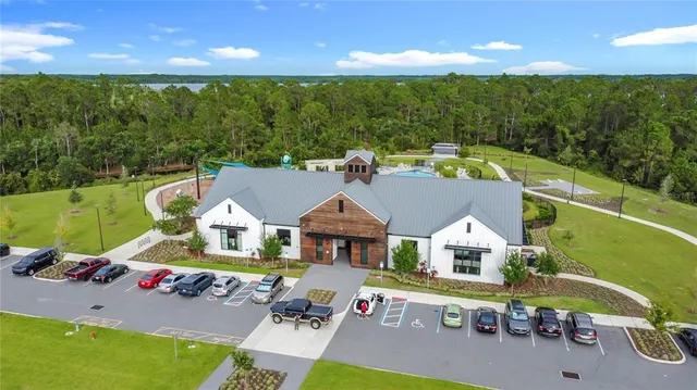 a view of an house with backyard space and balcony