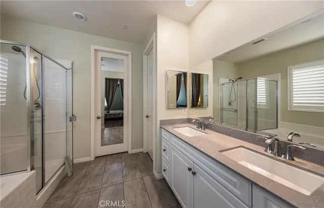 a bathroom with double vanity sinks and a mirror