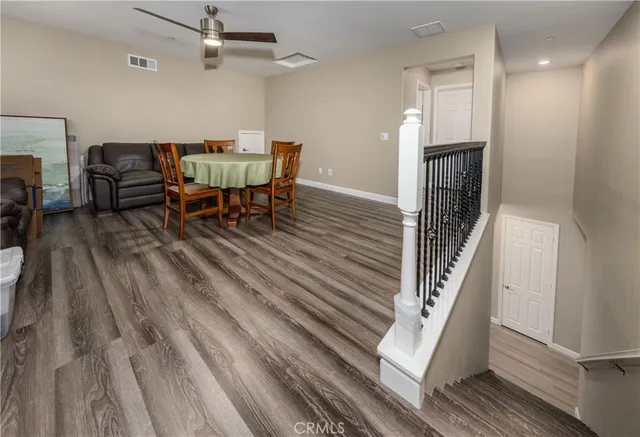 a dining room with furniture and wooden floor