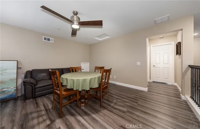 a dining room with furniture a rug and wooden floor