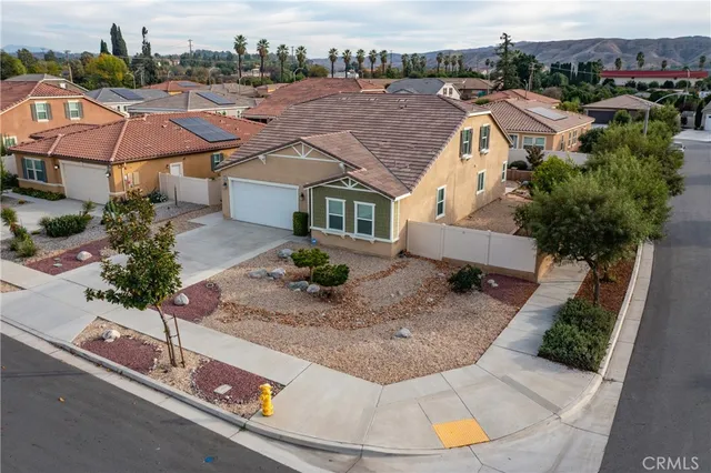 an aerial view of house with yard and ocean view