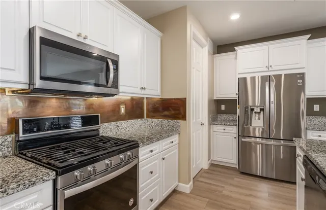 a kitchen with a stove microwave and refrigerator
