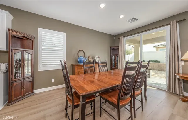 a dining room with furniture and wooden floor