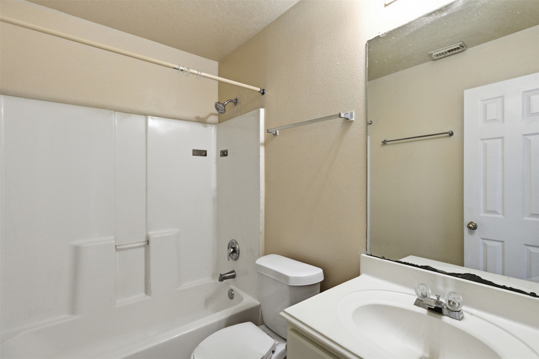 15738 Boonridge Road Houston, TX 77053 - Photo 9 of 31 Bright bathroom with a combination shower and tub, a sleek vanity with ample counter space, and a large mirror enhancing the space.