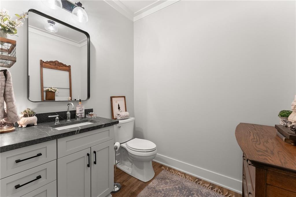 5822 John Burruss Road Cumming, GA 30040 - Photo 26 of 65 a bathroom with a granite countertop sink a toilet and a mirror