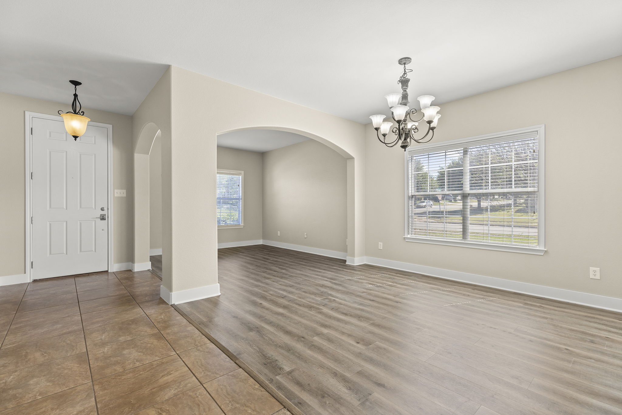 3013 Hawks Swoop Trail Pflugerville, TX 78660 - Photo 13 of 38 Formal living and dining with new vinyl plank flooring looking back to the front door.