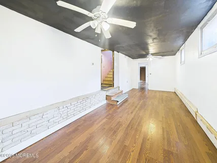 a view of hallway with wooden floor