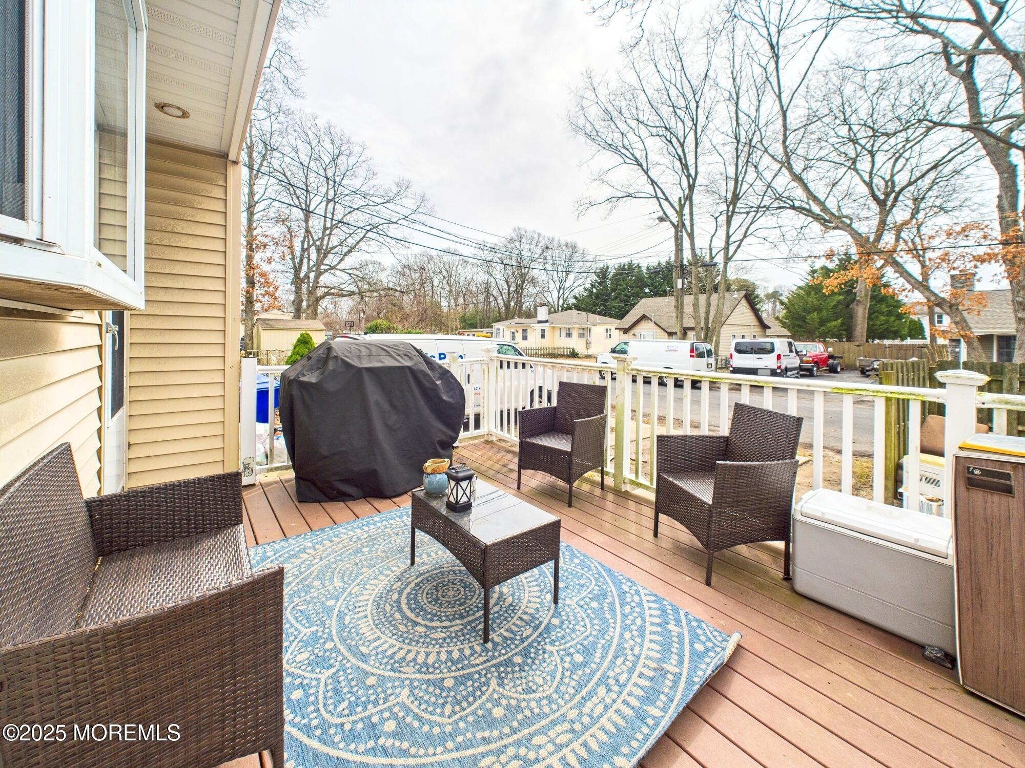 675 Mantoloking Road Brick, NJ 08723 - Photo 2 of 14 a living room with patio a couch and a fireplace