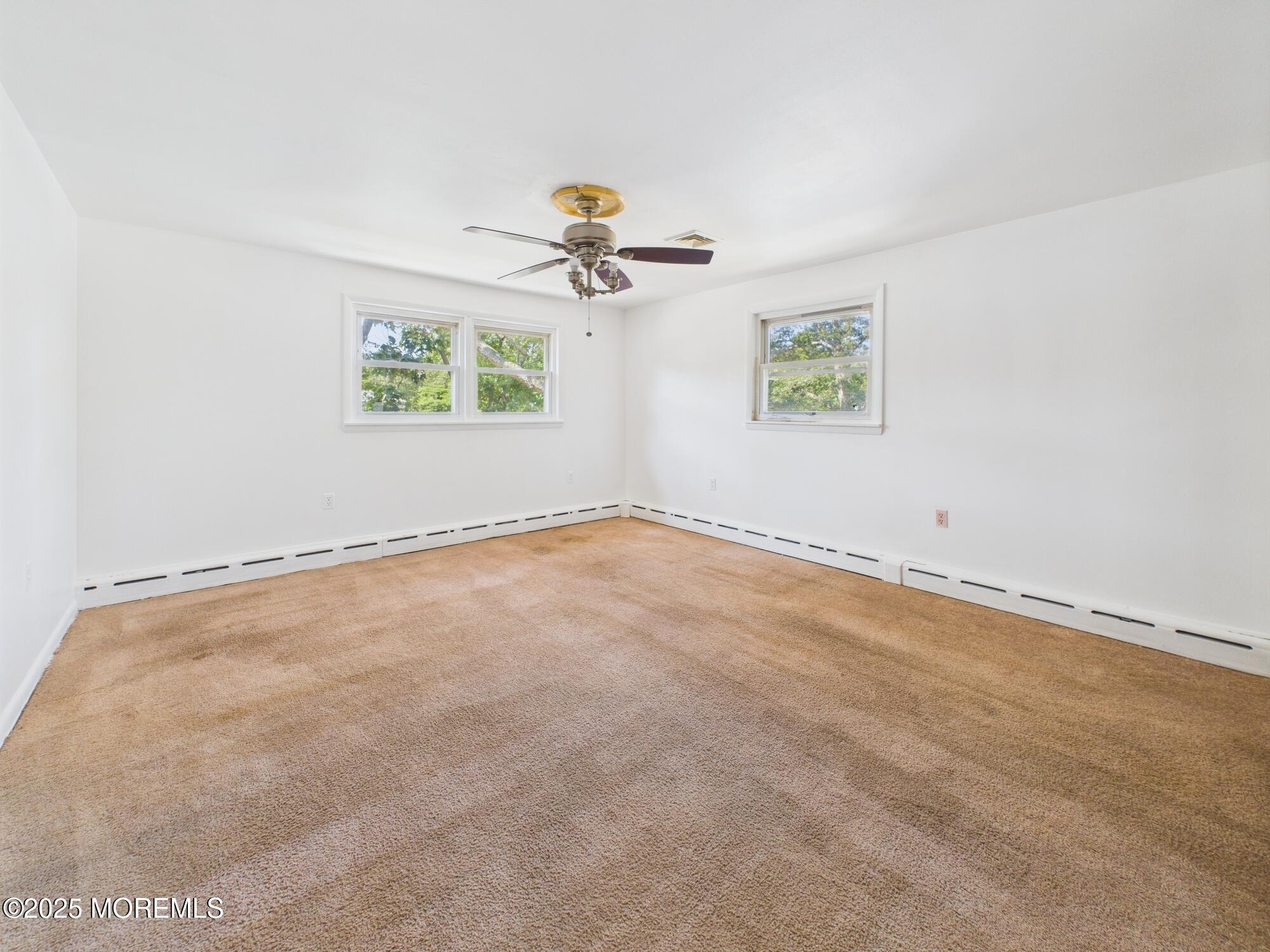 675 Mantoloking Road Brick, NJ 08723 - Photo 4 of 14 an empty room with windows and fan