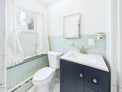 a bathroom with a sink toilet and mirror