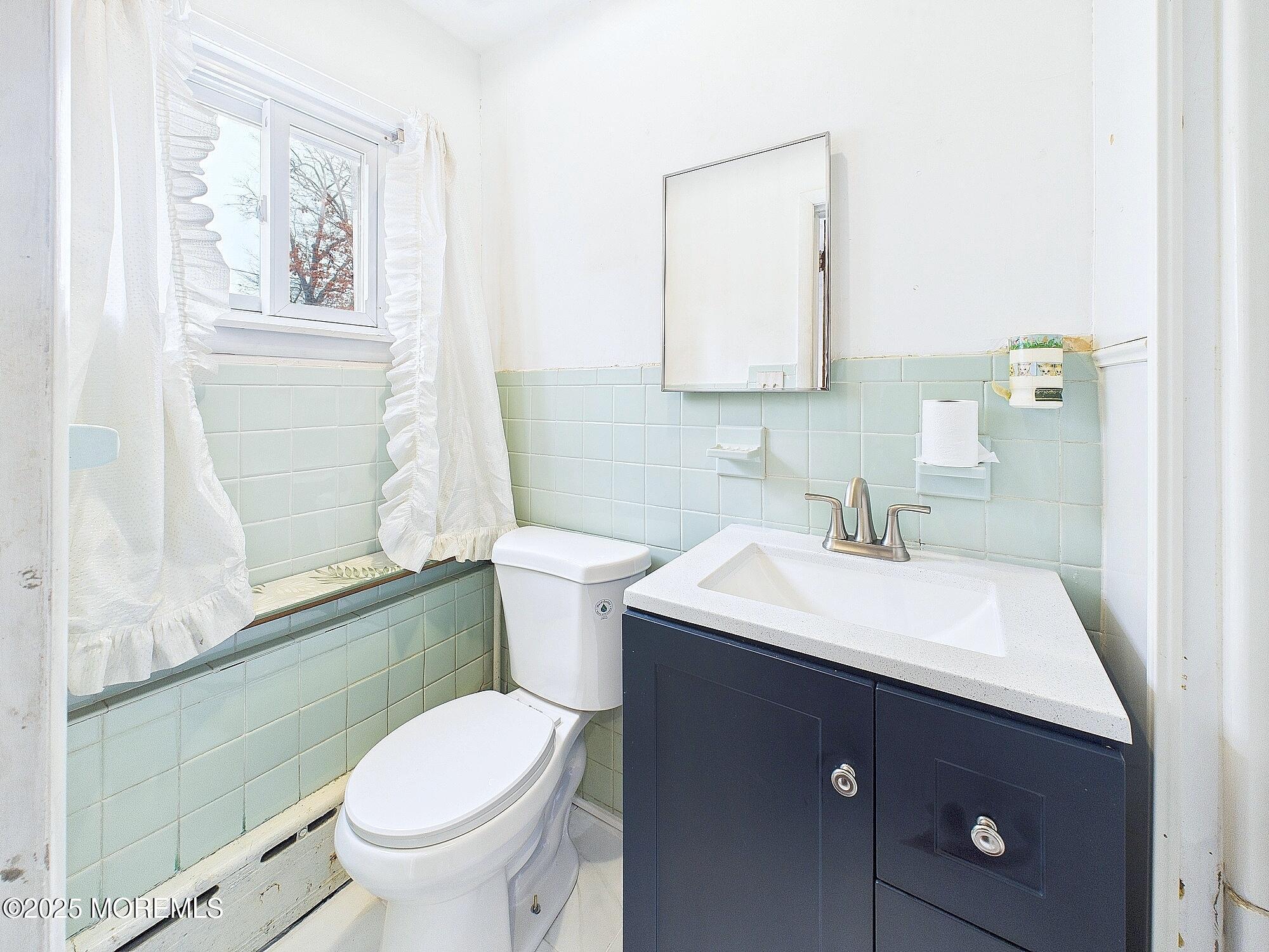 675 Mantoloking Road Brick, NJ 08723 - Photo 8 of 14 a bathroom with a sink toilet and mirror