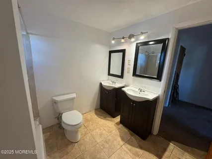 a bathroom with a sink toilet and mirror