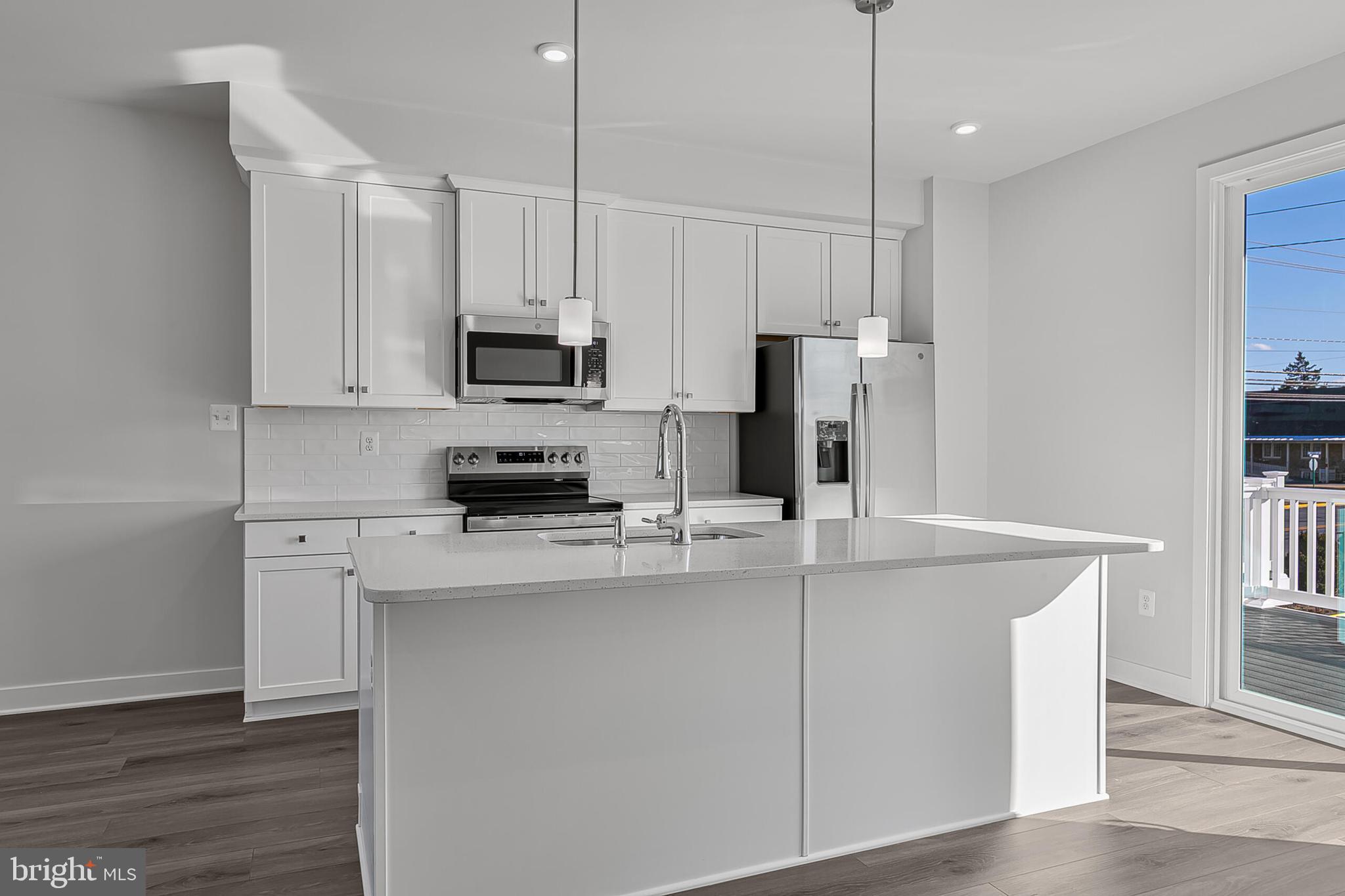 1 D Oasis Avenue Ranson, WV 25438 - Photo 10 of 38 a kitchen with kitchen island white cabinets and refrigerator