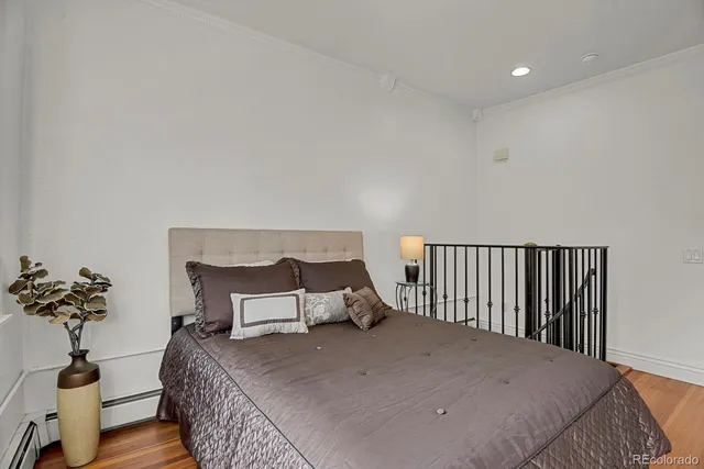 a bedroom with a bed and a potted plant