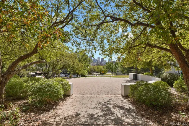 a view of a patio with couches table and chairs and potted plants