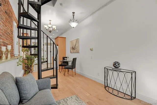 a view of a livingroom with furniture and staircase