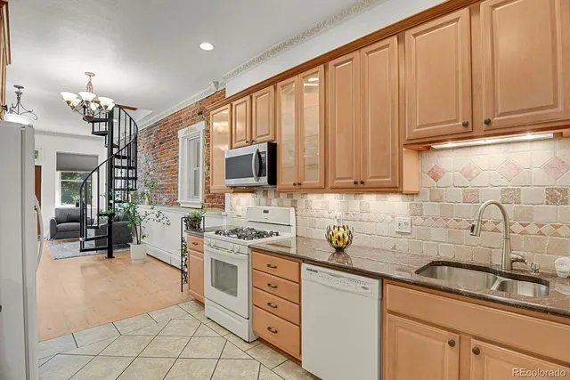 a kitchen with stainless steel appliances granite countertop a sink stove and cabinets