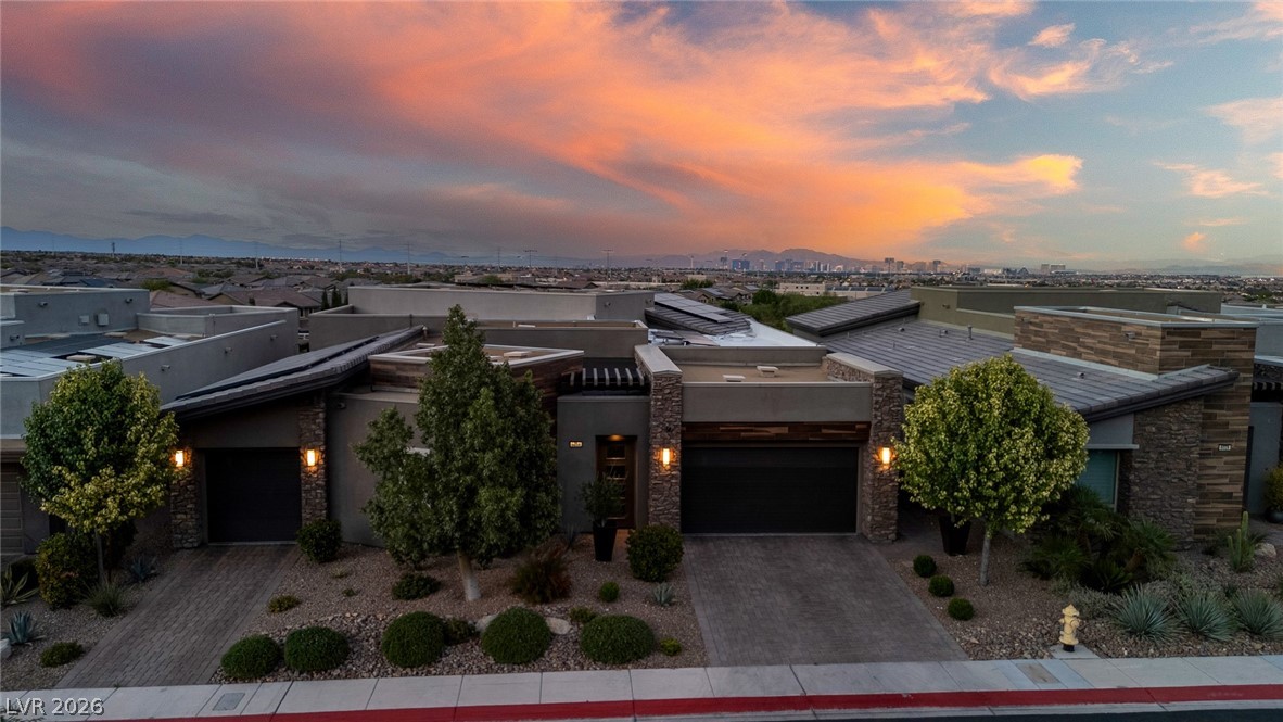 6014 Willow Ridge Court Las Vegas, NV 89135 - Photo 99 of 99 This captivating residence presents modern architecture under a dramatic sky, perfect for inspired living.