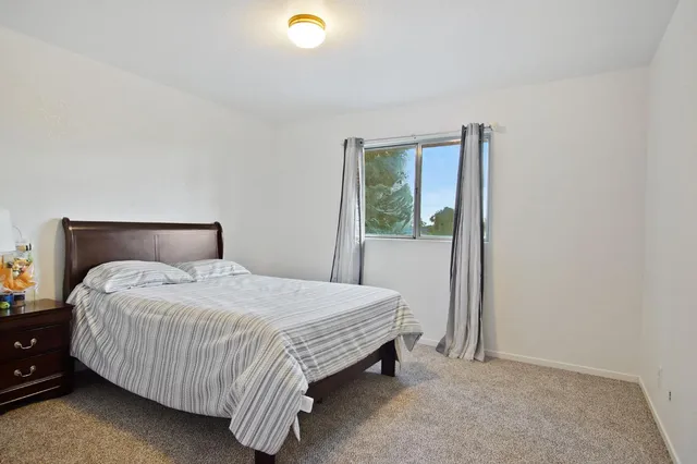 a bedroom with a bed and window