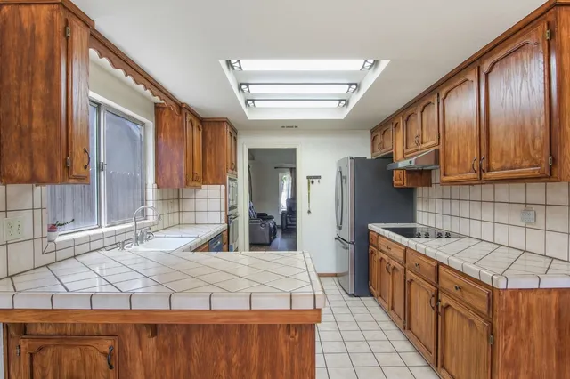 a kitchen with stainless steel appliances granite countertop a sink and cabinets