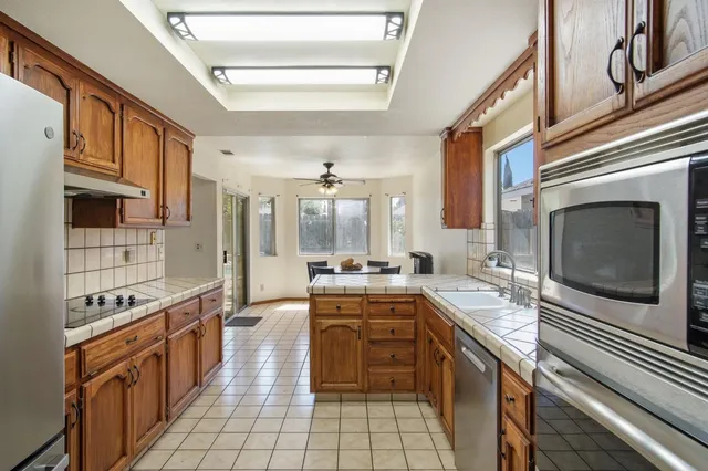 a kitchen with stainless steel appliances granite countertop a refrigerator and a sink