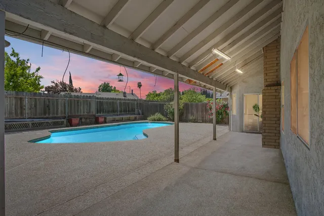 a view of swimming pool with a yard