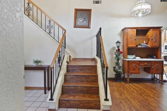 a view of entryway and hall with wooden floor