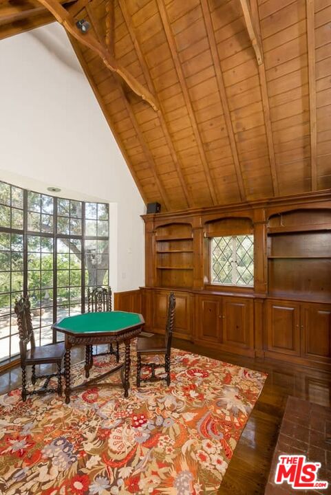 1957 Mandeville Canyon Road Los Angeles, CA 90049 - Photo 17 of 54 a living room with furniture a rug and a table