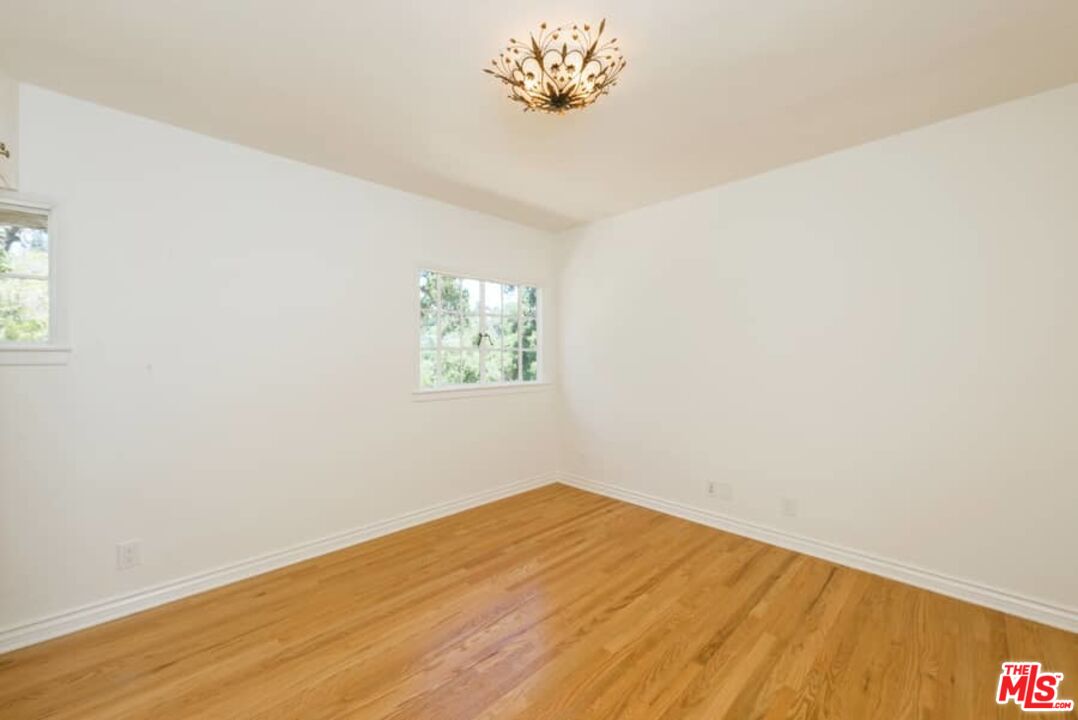 1957 Mandeville Canyon Road Los Angeles, CA 90049 - Photo 25 of 54 an empty room with a window