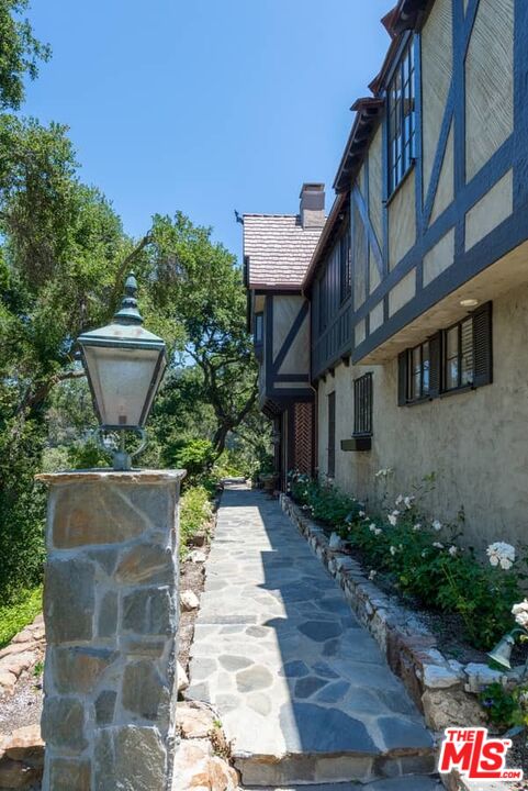 1957 Mandeville Canyon Road Los Angeles, CA 90049 - Photo 5 of 54 a view of a house with a garden