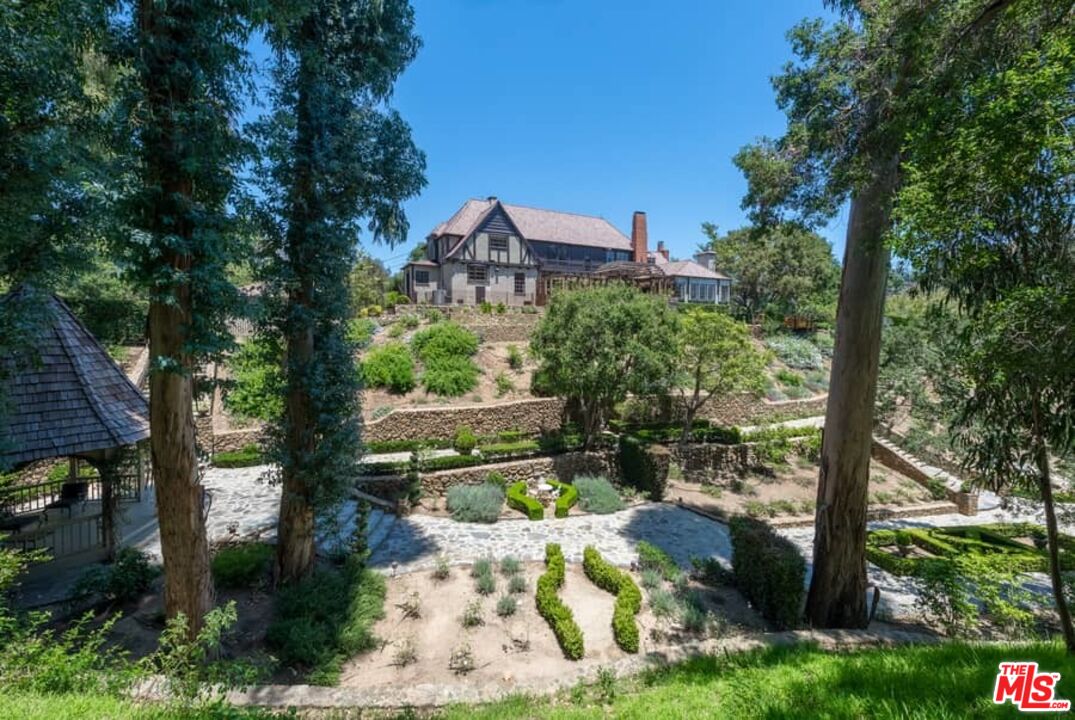 1957 Mandeville Canyon Road Los Angeles, CA 90049 - Photo 51 of 54 a view of a yard with plants and large trees
