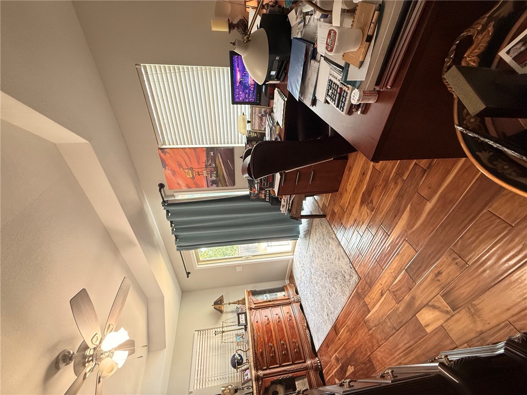 1224 River Road Pottsville, AR 72858 - Photo 13 of 37 Expansive room featuring wood-finish flooring, a tray ceiling, and a ceiling fan with integrated lighting
