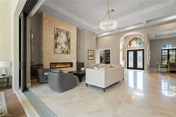 a living room with furniture and a chandelier