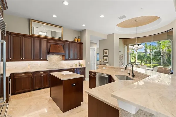 a kitchen with granite countertop a sink and stove