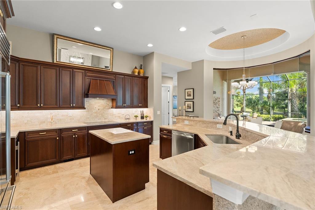 7400 Byrons Way Naples, FL 34113 - Photo 14 of 50 a kitchen with granite countertop a sink and stove